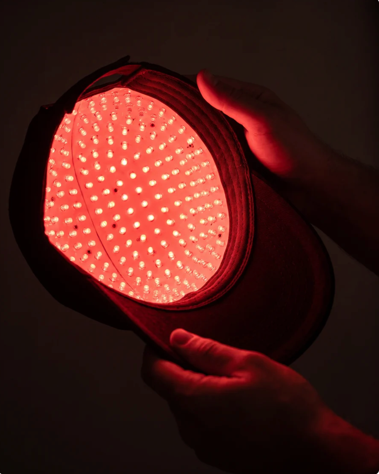 Inside of the Lumora cap held open, showing the dense array of 200+ 650nm red LEDs that sit against the scalp