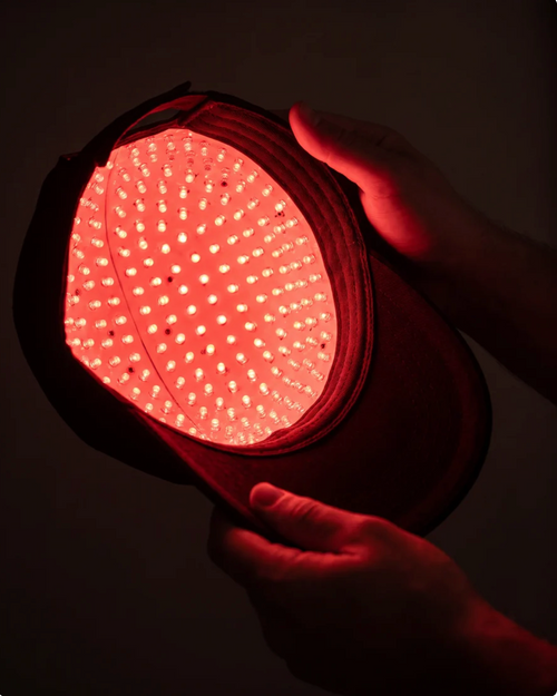 Inside of the Lumora cap held open, showing the dense array of 200+ 650nm red LEDs that sit against the scalp